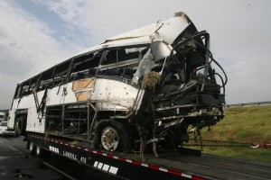 Crews work to move the charter bus off of U.S. Highway 75 near Sherman.